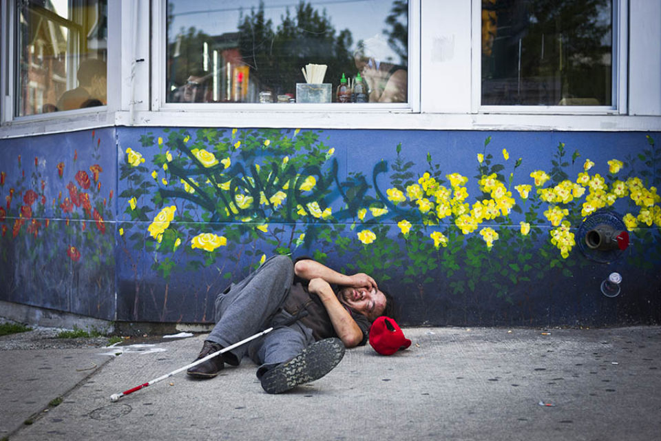 Homeless man outside restaurant