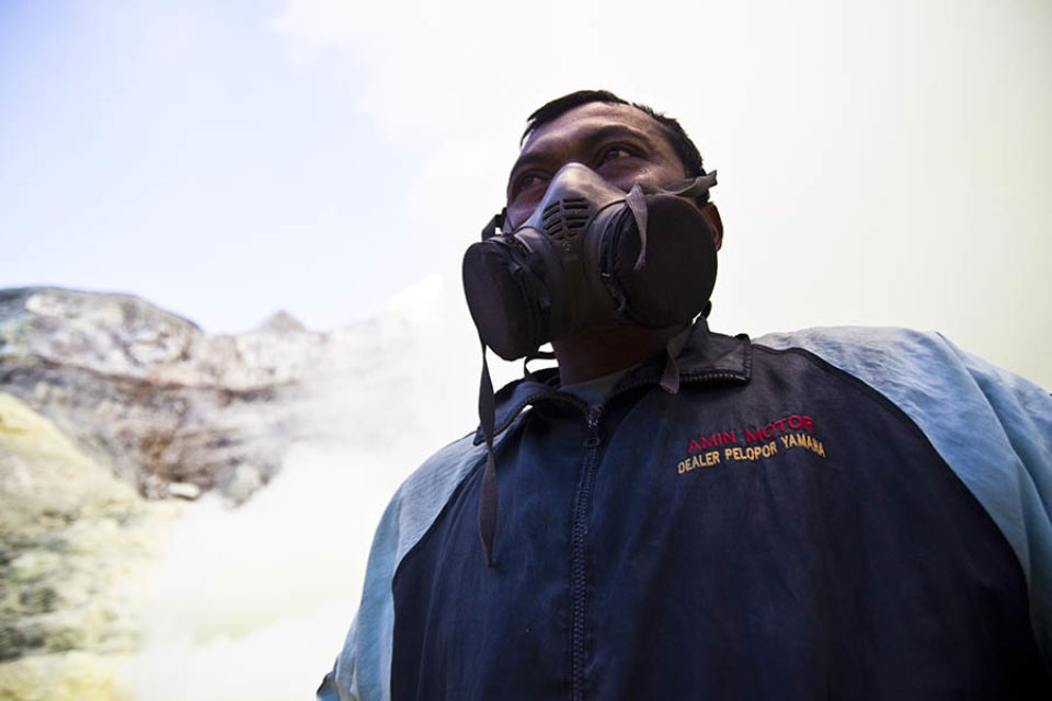 Sulphur miner wearing gas mask