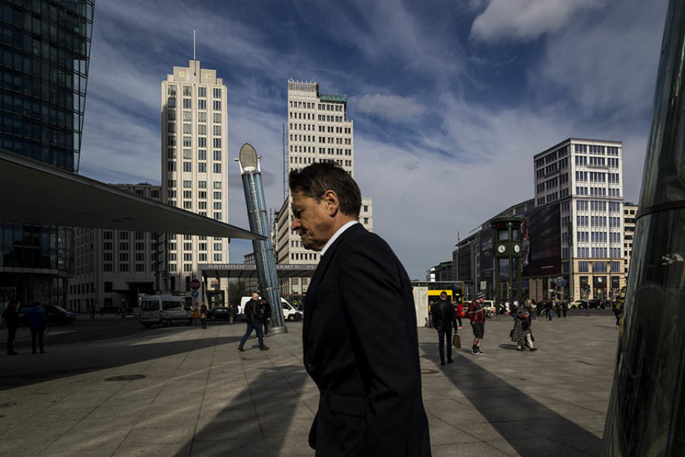 Businessman walking through Potsdamer Platz