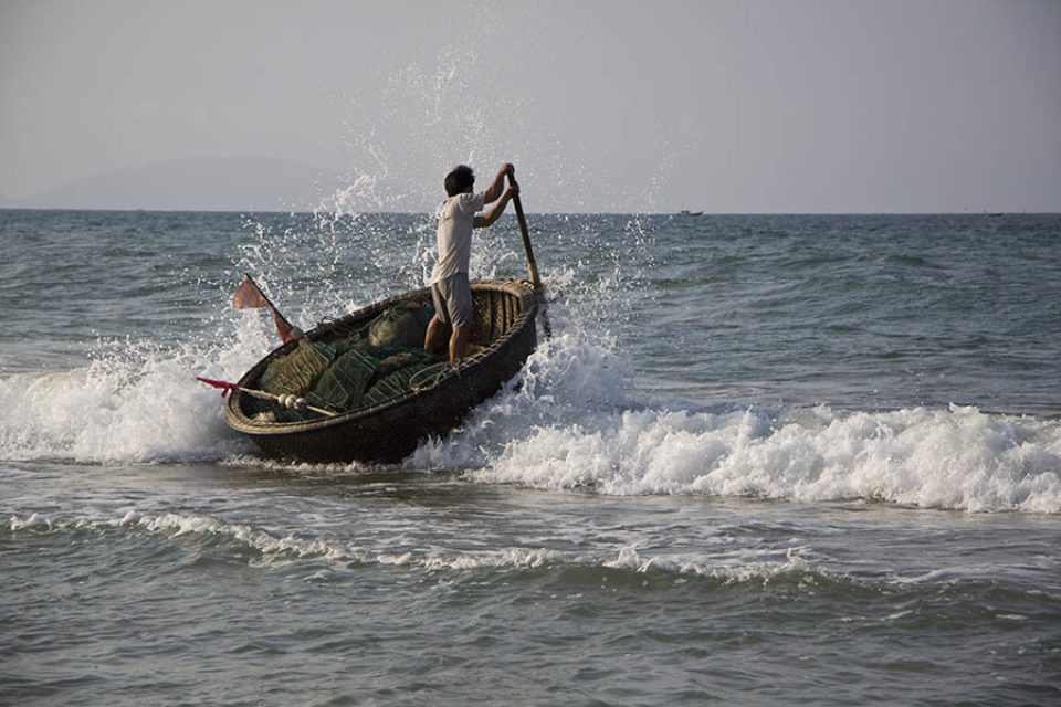 Coracle fisherman going to sea, Hoi An, Vietnam