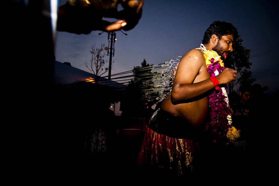 Entranced celebrant with kavadi hooks in back