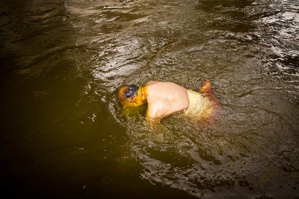 Festival celebrant bathes in river