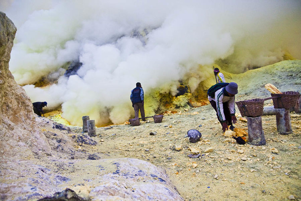Sulphur miners working in crater