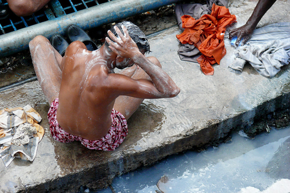 Men bathing in Delhi train station, India