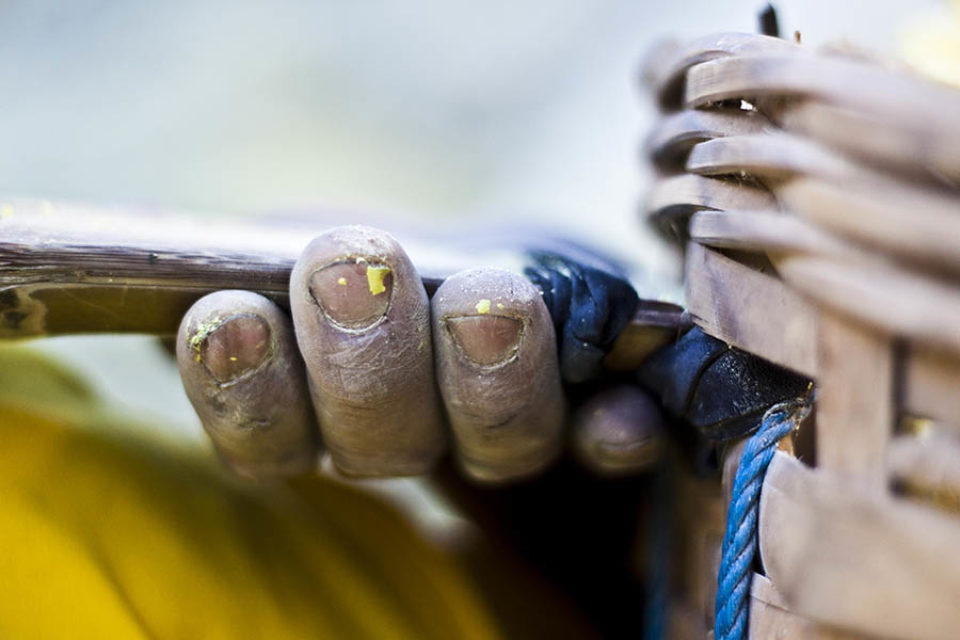 Sulphur flakes on miner's hands