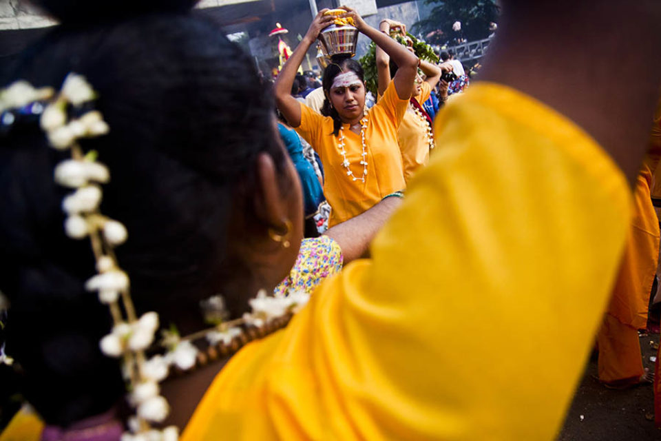 Female celebrants wait with kavadis