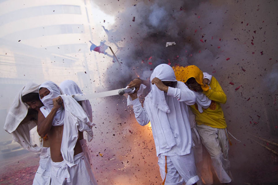 Firecrackers exploding over litter bearers during procession