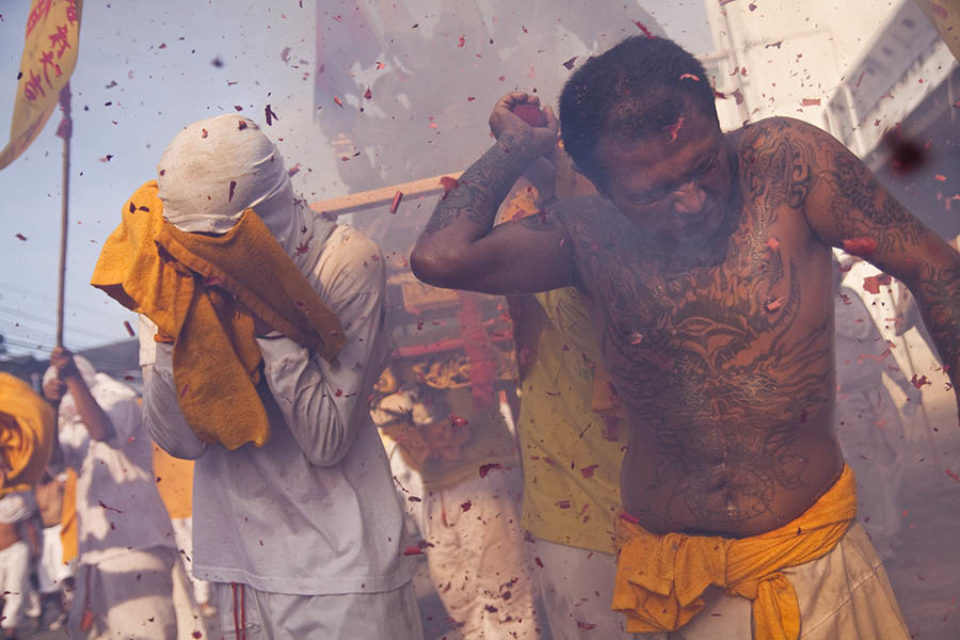 Litter bearers react to exploding firecrackers