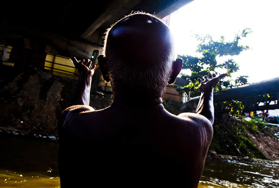 Celebrant praying in morning light