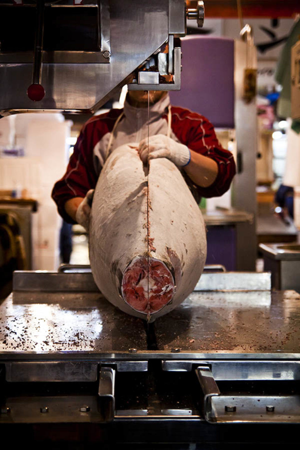 Fisherman sawing tuna at Tsukiji Fish Market