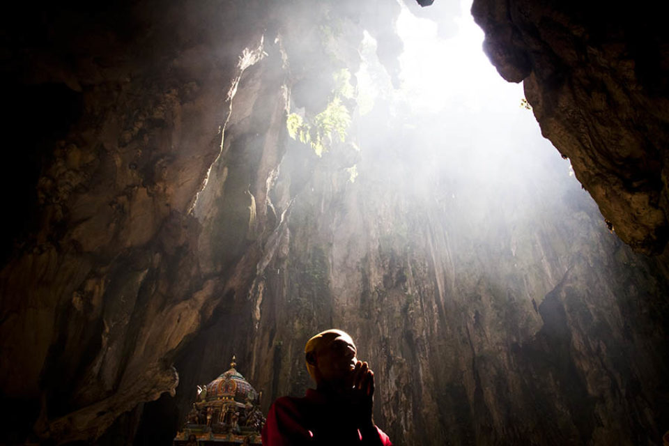 Celebrant praying inside Batu Caves