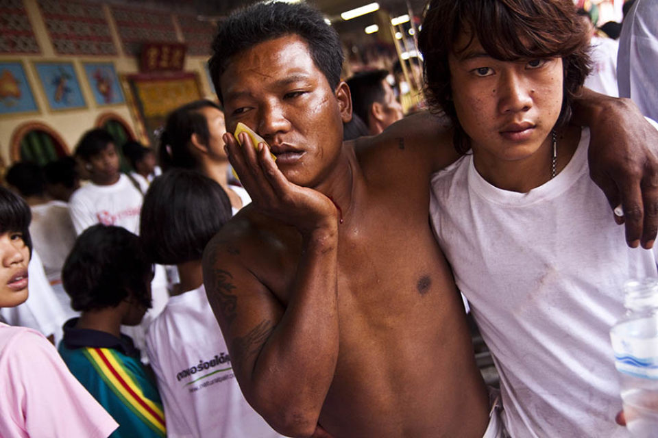 A ma-song holds his face after the procession