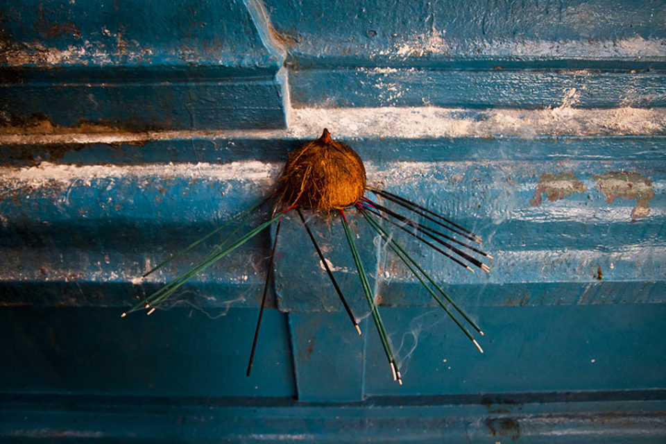 Incense sticks and coconut shell