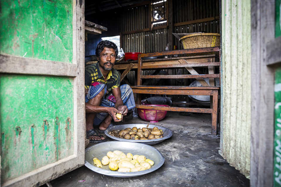 Man preparing food, Bangladesh