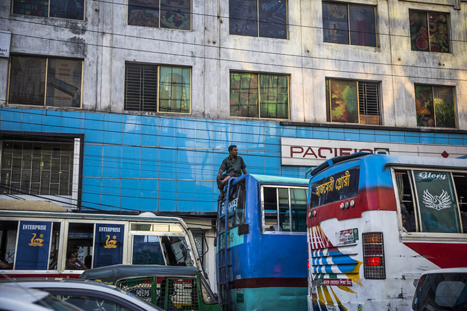 Editorial Photographer Montreal -man stuck in Dhaka traffic jam