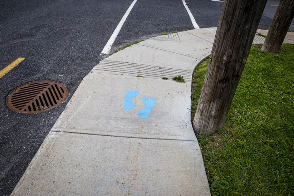 Blue painted sidewalk feet