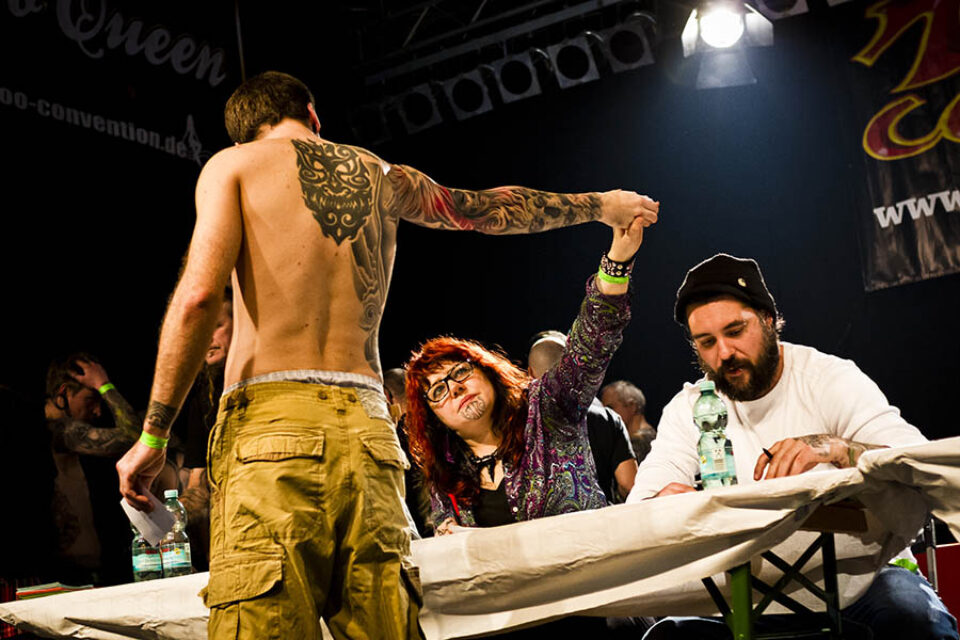 Montreal event photographer shot of convention participant has their tattoo judged