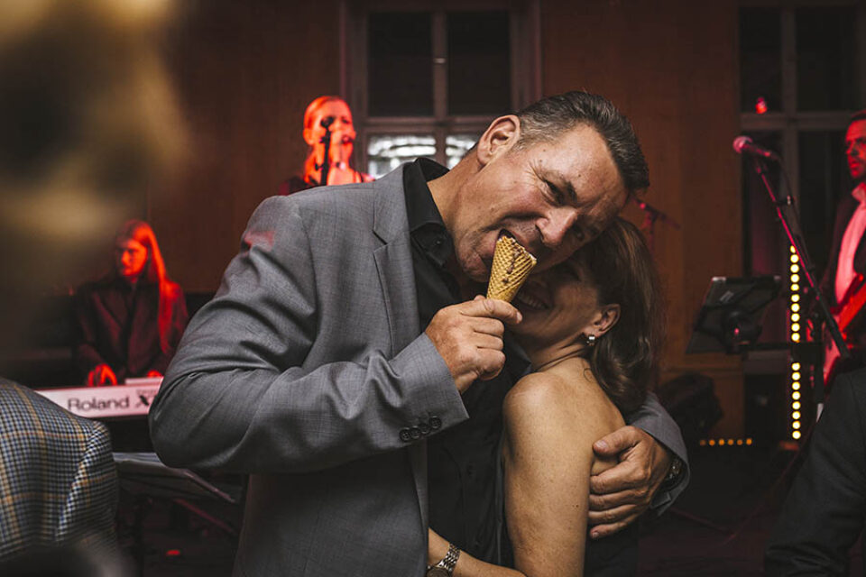 Montreal event photographer photo of a man eating ice cream on and event dancefloor