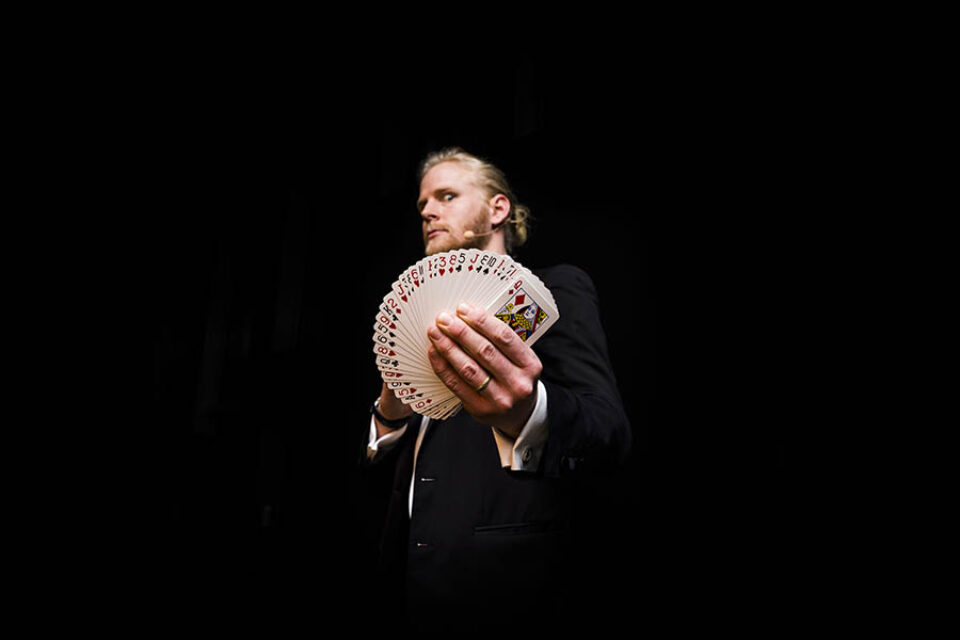 A magician doing a card trick by a trusted Montreal event photographer