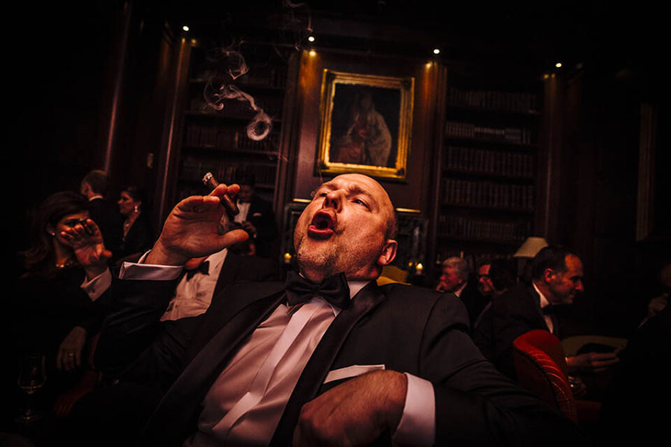 A man smokes a cigar at a formal event photographed by a Montreal photographer