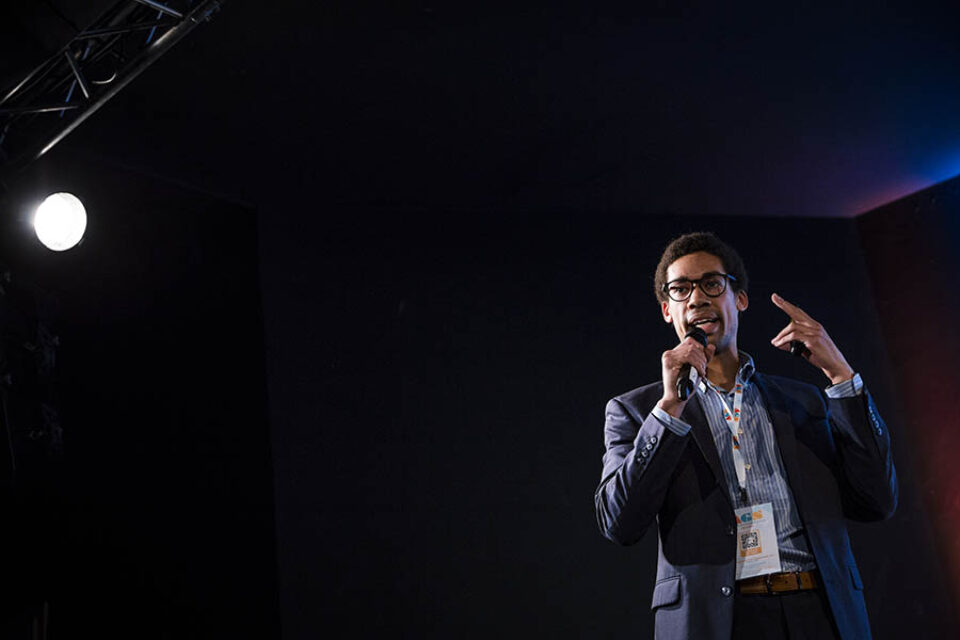 Man speaking onstage by professional Montreal event photographer