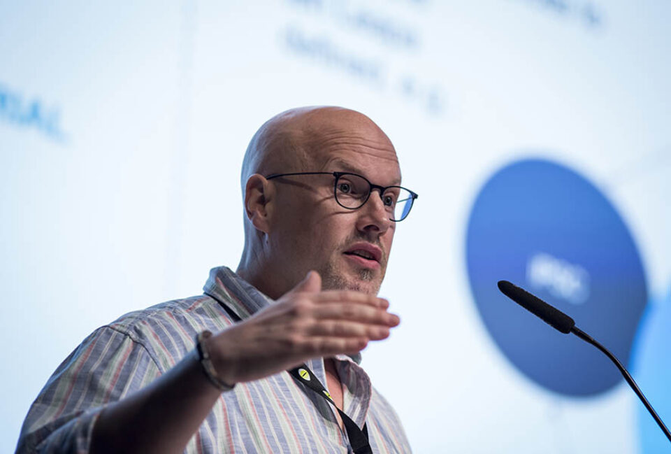 Presenter talking onstage at event