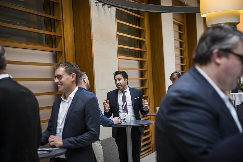 Delegates chat during a break
