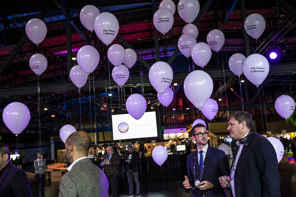 Event delegates chat near balloons