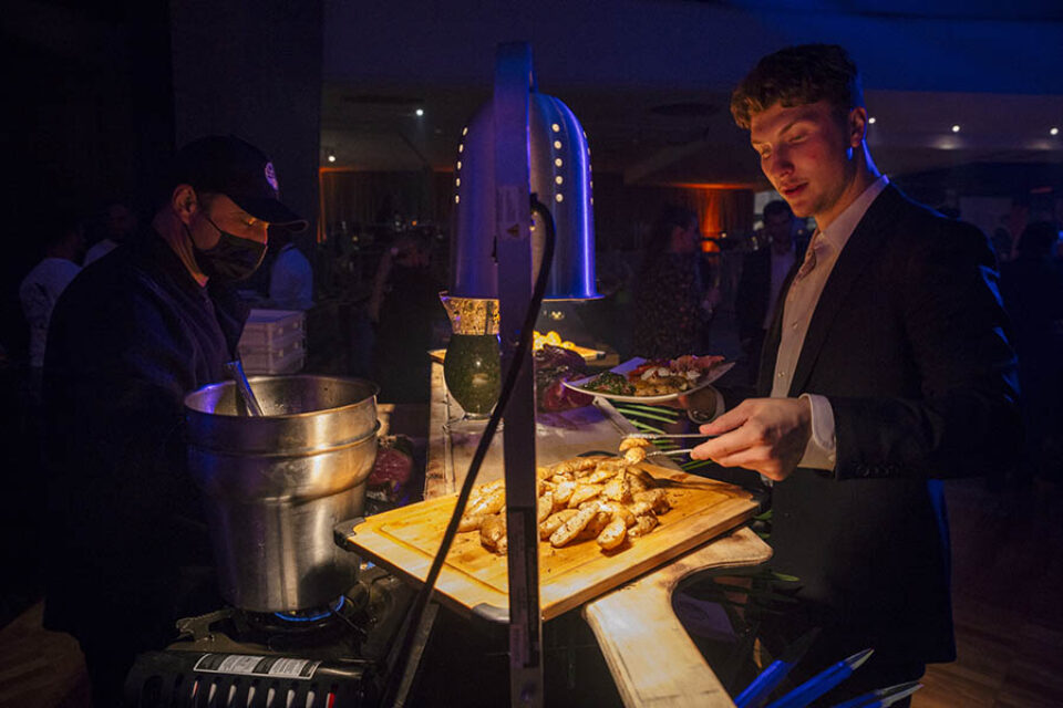 Young man getting food at a networking event in Montreal
