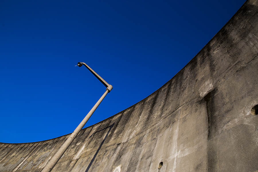 Lamppost against a curved concrete wall in Lisbon, Portugal