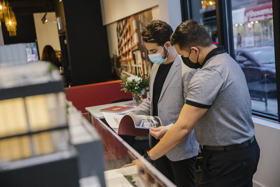 Clients look at real estate brochure at an event in Ottawa