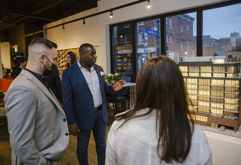 Broker shows clients condo scale model at Ottawa real estate event