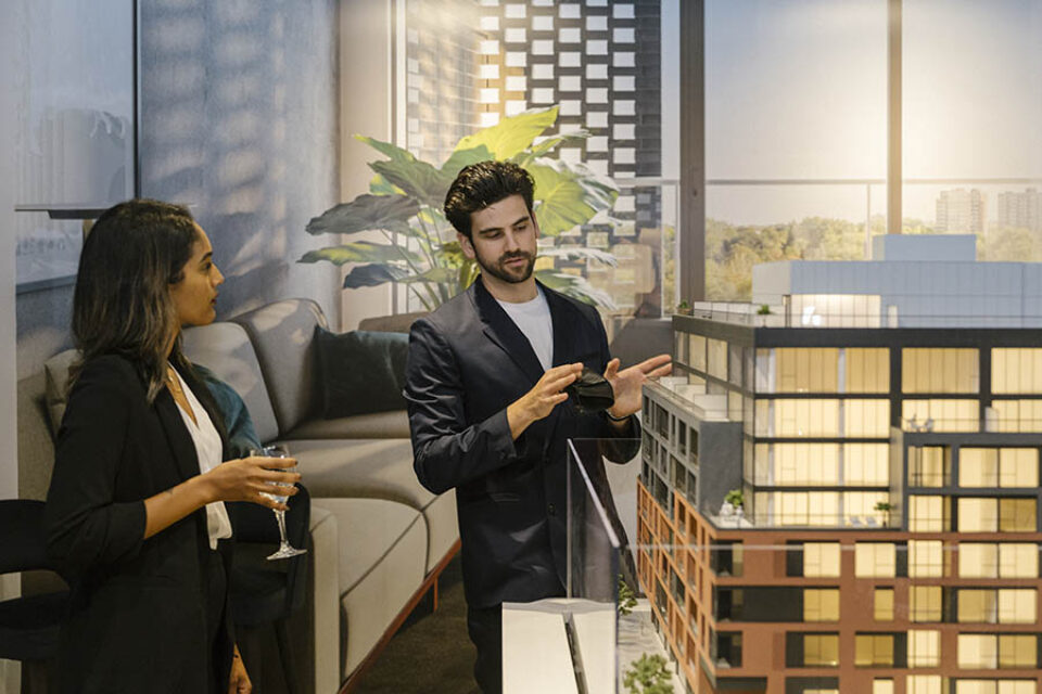Event photographer Ottawa shot of broker showing condo scale model at event