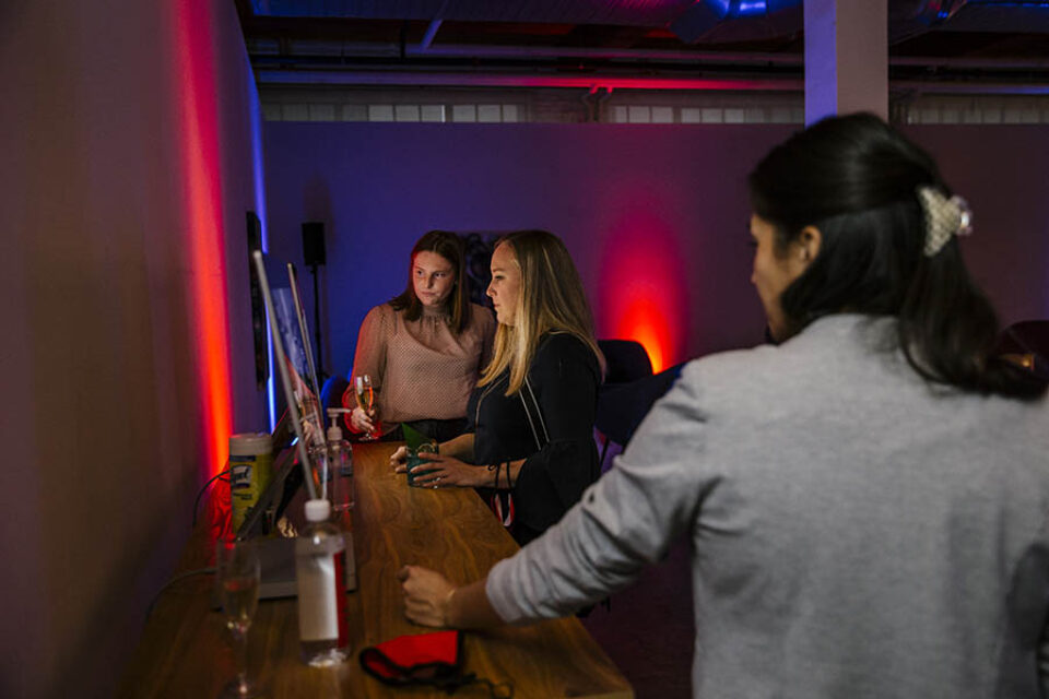 Women look at computer during real estate event