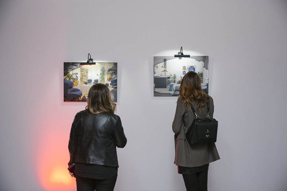 Guests look at real estate event art