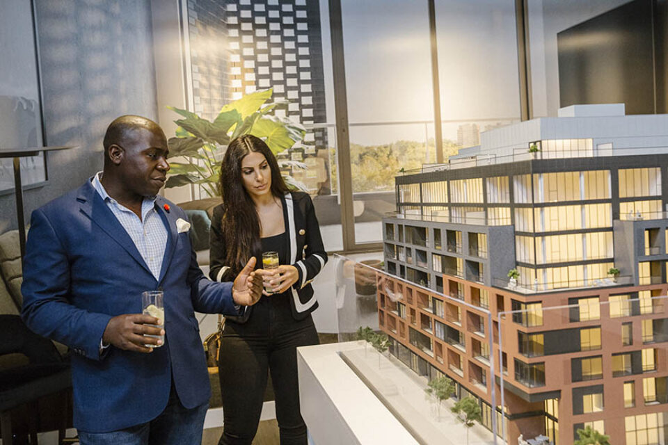 Broker shows client Ottawa condo real estate scale model