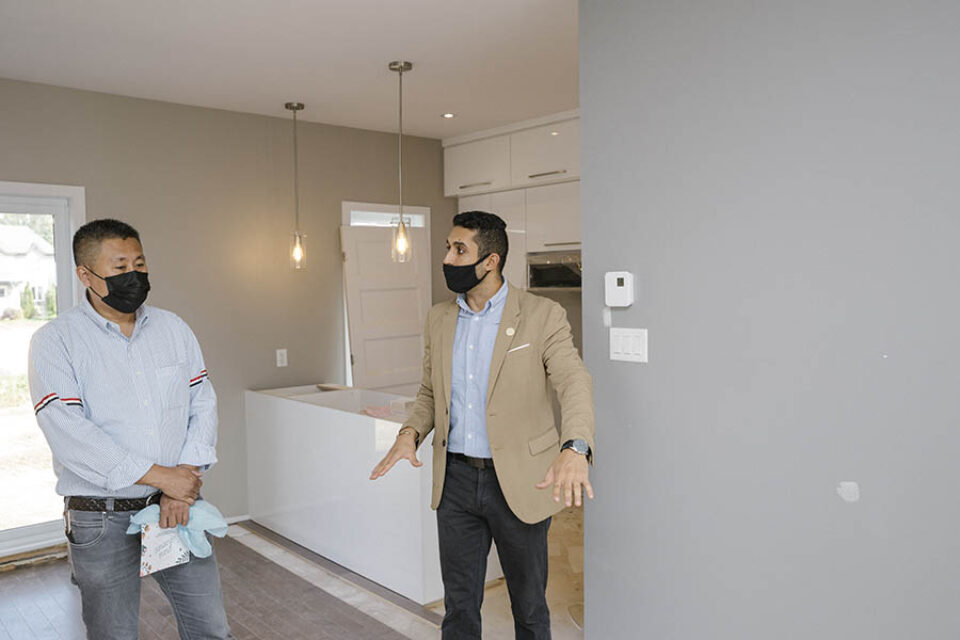 A broker shows a client model residence