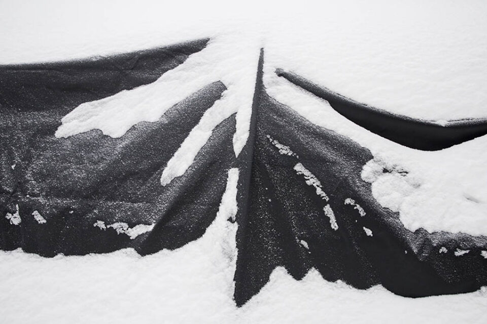 Snow-covered winter car shelter