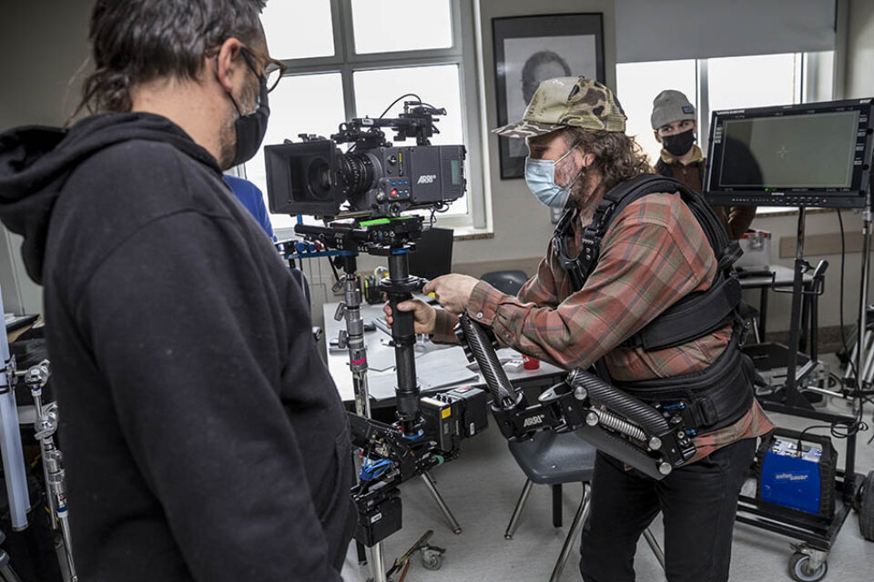 Camera operator balancing camera