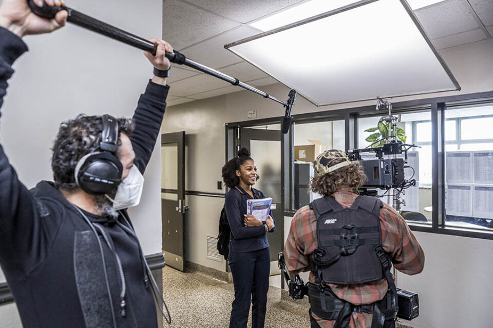 Filming student in corridor