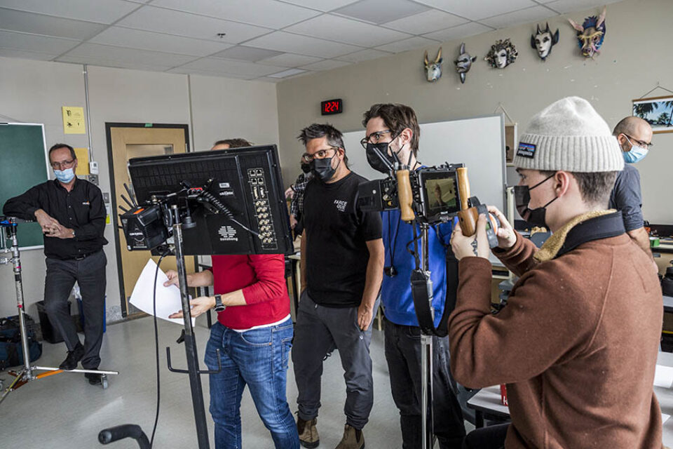 Director and assistants watch filming