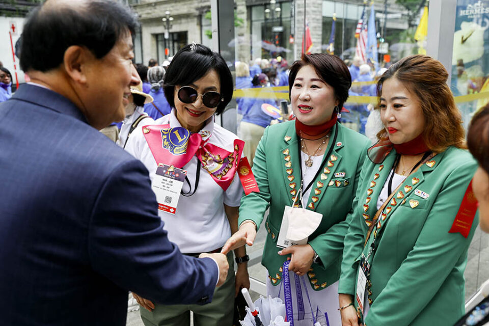 Delegates greet each other at Montreal street parade during Lions Club event