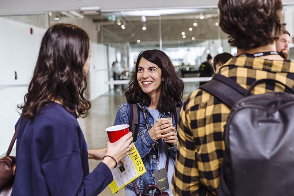 Attendees chat at corporate tech event in Montreal