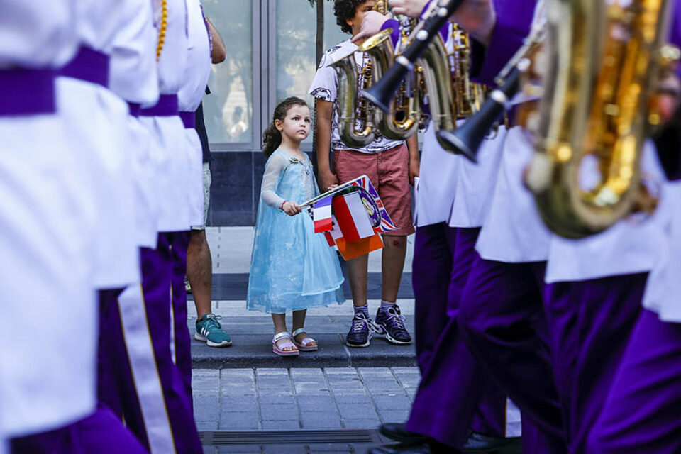Montreal event photography - Young girl watching marching band at Montreal street parade