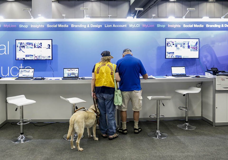 Visually impaired convention delegate with guide dog at an event in Montreal