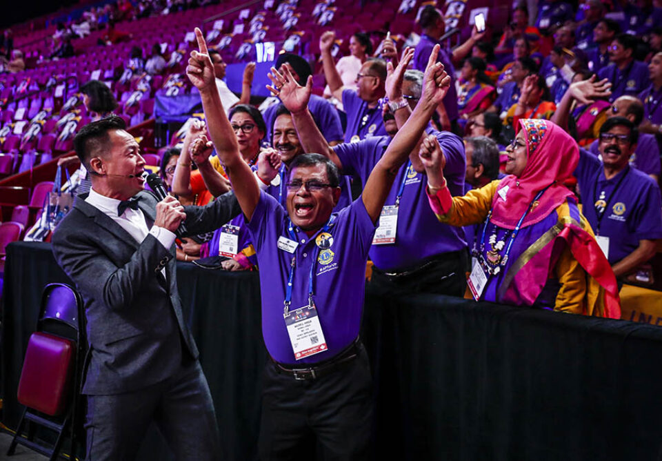 Indian delegation with presenter at convention, Bell Centre in Montreal