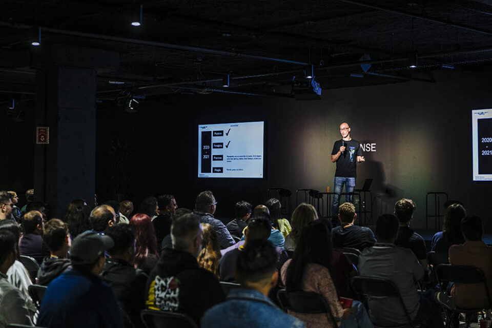 Presenter onstage with audience watching, Montreal tech event photography