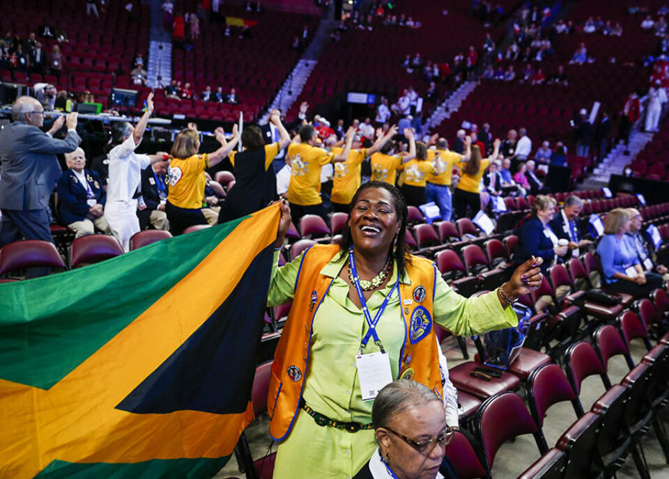 Member of Jamaican delegation with flag in Montreal Bell Centre