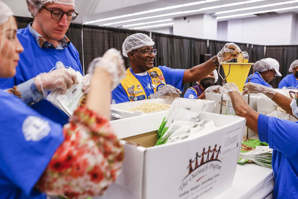 Volunteers packaging food at convention