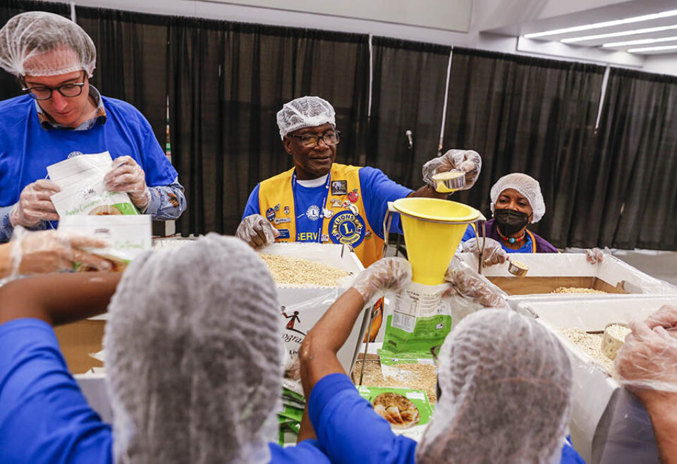 Volunteers packaging food at convention